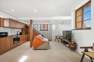 a living room with a couch and a kitchen at Duplex Suite Old Town in Antibes +19 photos