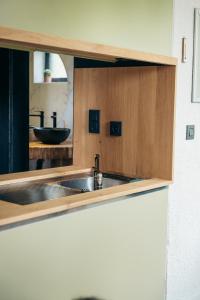 a kitchen with a sink and a counter top at Cocoon Ny - DURBUY in Hotton +51 photos