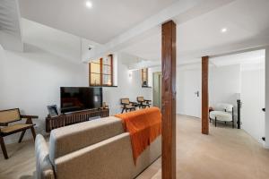 a living room with a couch and a television at Duplex Suite Old Town in Antibes