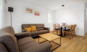 a living room with a couch and a table at Figaro in Leukerbad