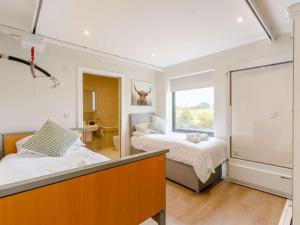 a bedroom with two beds and a large window at 3 Bed in Alcester 88396 in Coughton