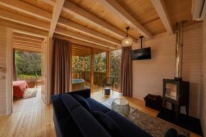 a living room with a blue couch and a fireplace at HolaCamp Camino in O Pino 