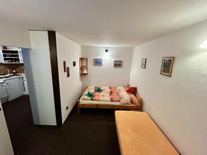 a small room with a bed and a kitchen at Privát Podstata in Benecko