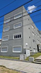 a gray building with white windows on the side of it at La gracie in San Bernardo