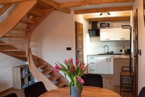a kitchen and a table with a vase of flowers at Domki Widokowe Wisła in Wisła