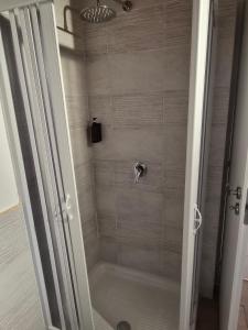 a shower with a glass door in a bathroom at Cattedrale Central Rooms in Palermo