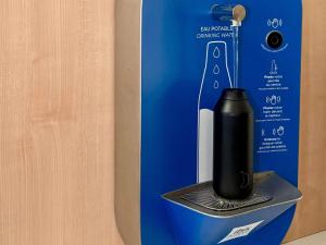 a black electric toothbrush in a holder in a box at Ibis Budget Bayeux in Bayeux