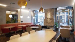 a restaurant with tables and chairs and a bar at Petit Palace Puerta del Sol in Madrid