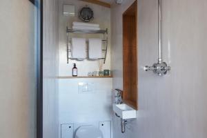 a bathroom with a toilet and a sink at The Cabana Luxury Award Winning Tiny Home with Hot Tub and Private Garden 2 mins Walk to Ryde Beach in Ryde