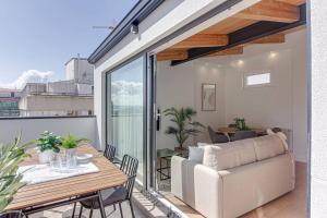 a balcony with a table and a couch at Santa Lucía in A Coruña