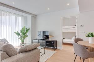 a living room with a couch and a table at Santa Lucía in A Coruña +27 photos
