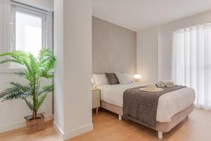 a bedroom with a bed and a plant in it at Santa Lucía in A Coruña