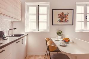 a kitchen with a table with a bowl of fruit on it at Old Quarter Boutique in A Coruña +4 photos