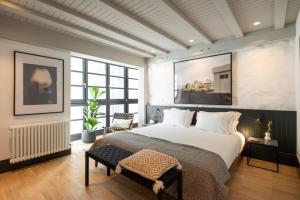 a bedroom with a large bed and a large window at ART Boutique in A Coruña