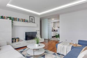 a living room with a couch and a table at Riazor Ocean View Apartment in A Coruña +12 photos