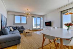 a living room with a table and a couch at Blue Ocean Penthouse in A Coruña