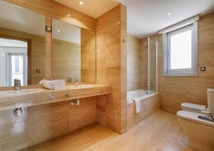 a bathroom with a sink and a toilet and a mirror at Blue Ocean Penthouse in A Coruña +21 photos