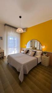 a bedroom with a large bed and a large mirror at Hotel Splendid Suisse in Bellaria-Igea Marina