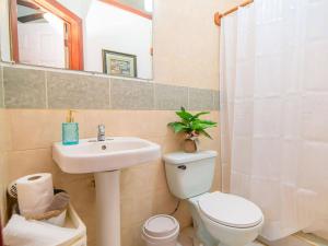 a bathroom with a sink and a toilet and a mirror at West Bay Room, Pool, Fridge, Shuttle, Dive in West Bay