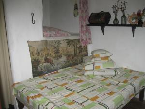 a bed with a quilt on it in a bedroom at Koryakivskyi Rai in Dmitrenki +72 photos