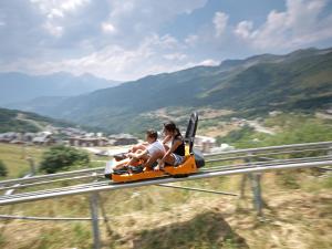 a group of people riding on a roller coaster at Appartement 6 pers, pieds des pistes, St-François-Longchamp - FR-1-807-105 in Saint-François-Longchamp