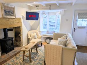 ein Wohnzimmer mit Sofa und Kamin in der Unterkunft Normanby Cottage Runswick Bay in Runswick