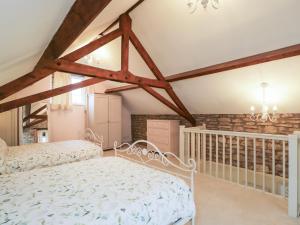 a bedroom with a white bed and a stone wall at Granary Cottage in Chippenham +20 photos