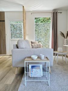 a living room with a couch and a table at Huisje Rixtel in Aarle-Rixtel