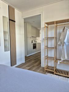 a room with a bed and a kitchen at Huisje Rixtel in Aarle-Rixtel