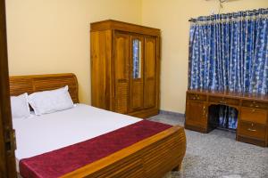 Ένα ή περισσότερα κρεβάτια σε δωμάτιο στο Gods Own Homestay