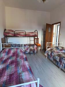 a bedroom with two bunk beds and a window at Il Rifugio di Mario in Monzuno