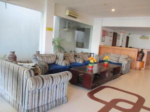 a living room with two couches and a coffee table at Hotel Caravan in Jakarta