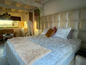 a bedroom with a large bed with a blue comforter at Guest Rooms by Art Bruges in Jabbeke +69 photos