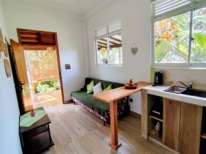 a living room with a green couch and a table at Green Eyes Villa in Habaraduwa Central