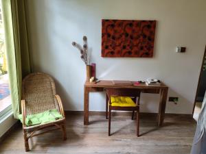 a desk and two chairs in a room at Green Eyes Villa in Habaraduwa Central +20 photos
