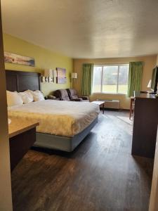 a hotel room with a bed and a large window at Parkwood Lodge in Fish Creek +48 photos