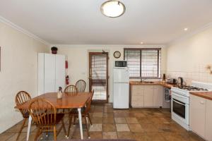 
a kitchen with a stove, refrigerator, sink, and dishwasher at The Apartment - Moyston in Moyston
