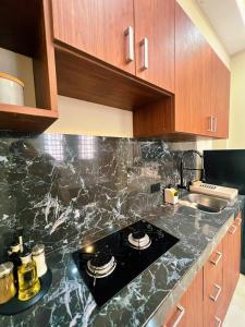 a kitchen with a granite counter top with a stove at Exclusive and Central Studio Apartment in Trinidad