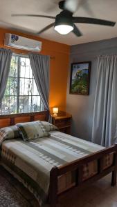 a bedroom with a bed and a ceiling fan at Casa Maruka in San Ignacio
