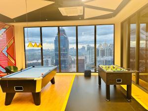 two pool tables in a room with a view at Majestic Residence KLCC By Homestay in Kuala Lumpur