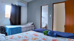 En eller flere senge i et værelse på Residencial Vila Marambaia Itacaré