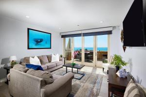a living room with two couches and a view of the ocean at 700-104 Water Front Condo w AC in Oceanside