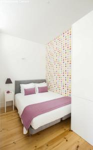 a bedroom with a bed and a wall at Charming Apartments in Historic Centre - Inside Porto Apartments "Flores" in Porto