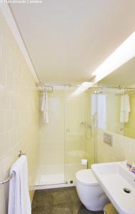a bathroom with a shower and a toilet and a sink at Charming Apartments in Historic Centre - Inside Porto Apartments "Flores" in Porto