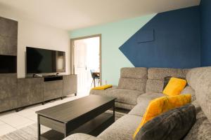 a living room with a couch and a tv at Modern 3-Bedroom Home in Quiet Cul-de-Sac w Parking by Rework Accommodation in Saltney