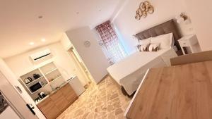 a bedroom with a bed and a wooden table at Ughetti Apartment in Palermo