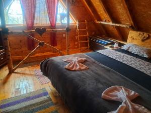 a bedroom with two beds in a log cabin at Kuca za odmor in Vitez