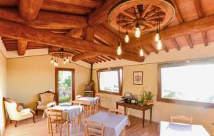 a restaurant with tables and chairs and wooden ceilings at Pet Friendly Home In Pescina in Tepolini