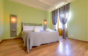 a bedroom with a white bed and a window at Pet Friendly Home In Pescina in Tepolini +26 photos