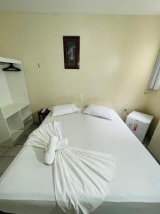 a large white bed in a bedroom with a picture on the wall at Hotel Transbrasil in Belém +37 photos